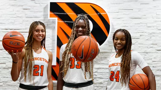 Players holding basketballs