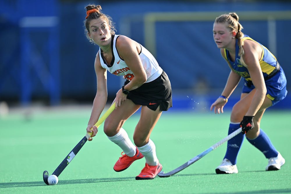 Players playing field hockey